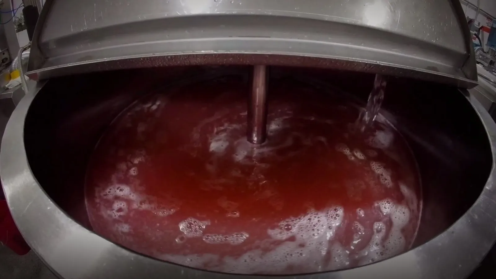 Cooking kettle with red gummy mass mid-batch